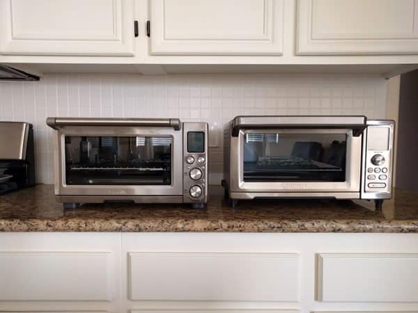 Two large toaster ovens on a kitchen counter.