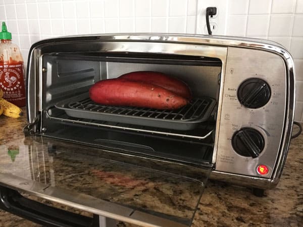 Sweet potatoes baking in a small toaster oven