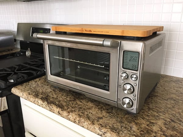 Cutting board sitting on top of a Breville Smart Oven Pro