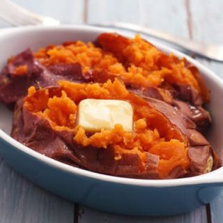 Baked sweet potato with butter in a baking dish