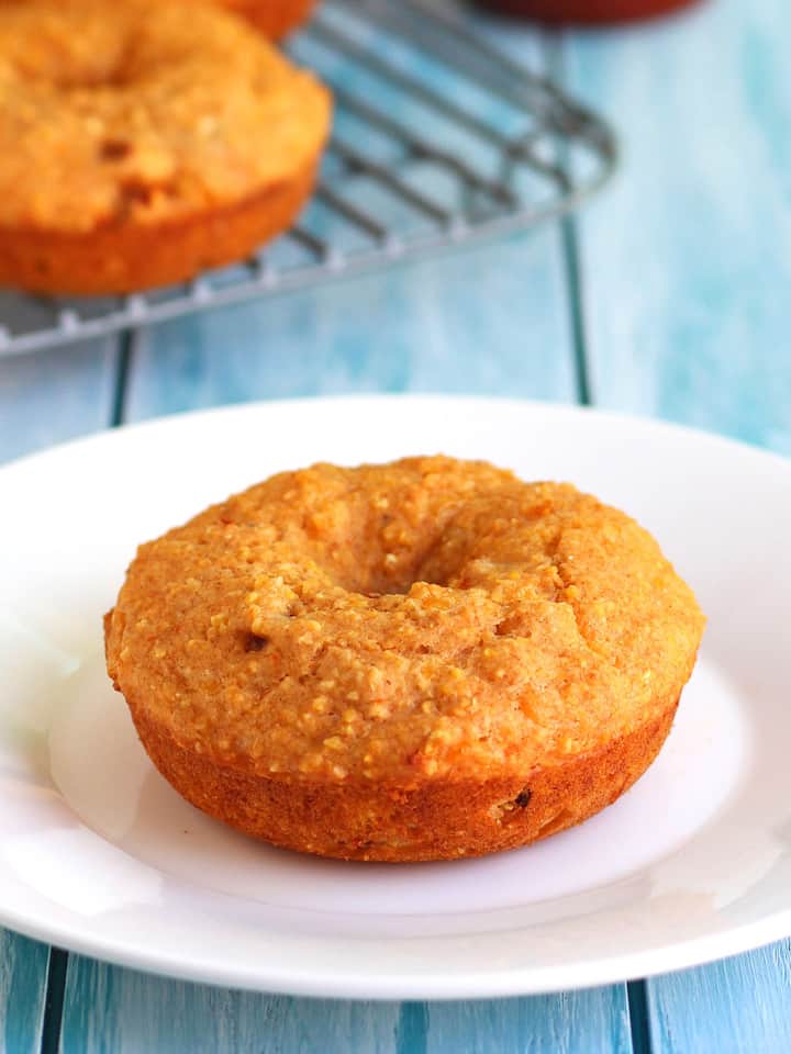 White plate with a cheddar cornbread donut.