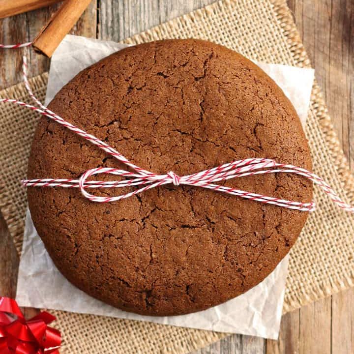 Large cookies tied with a twine bow on a wooden table.