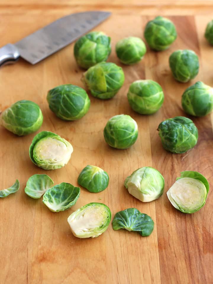 Sliced brussels sprouts on a cutting board.