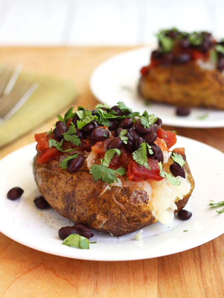 Baked potato topped with black beans and salsa.