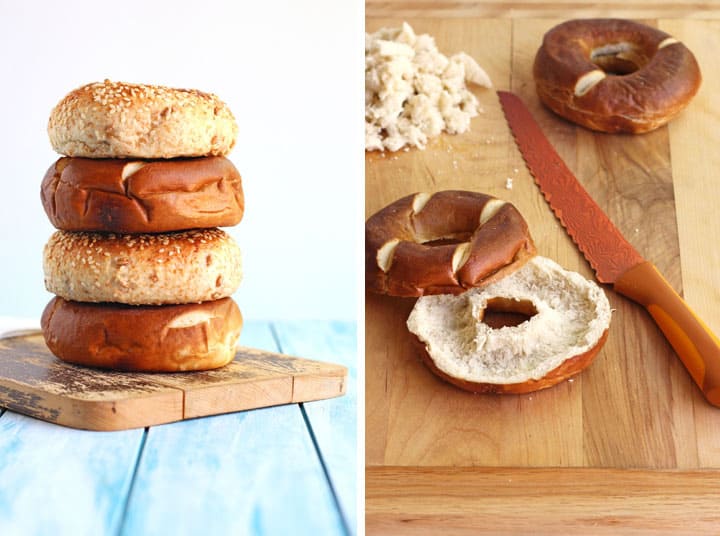 Stack of bagels on a cutting board and and bagel scooped out in the center.