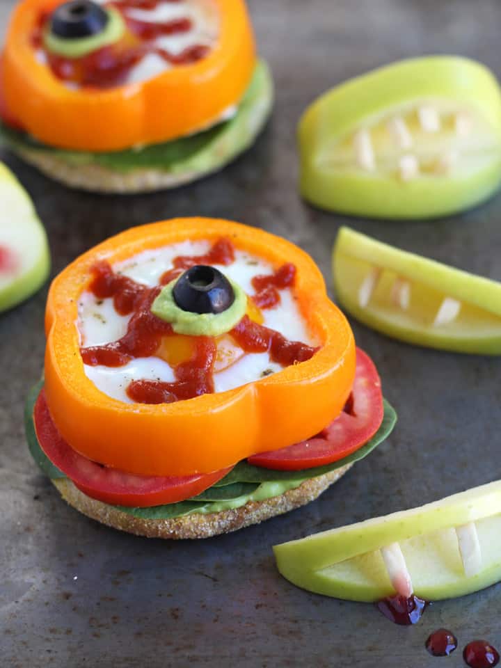 Eggs baked in bell pepper slice on a sheet pan.