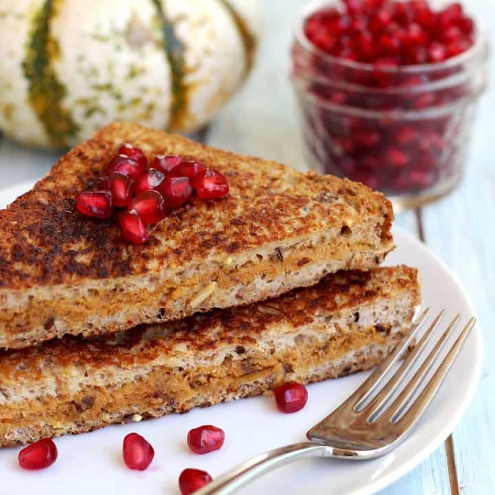 Stuffed french toast topped with pomegranate seeds.