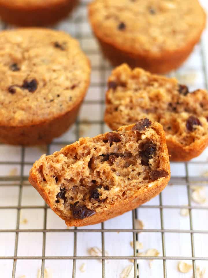 Closeup of muffin split in half showing raisins inside.