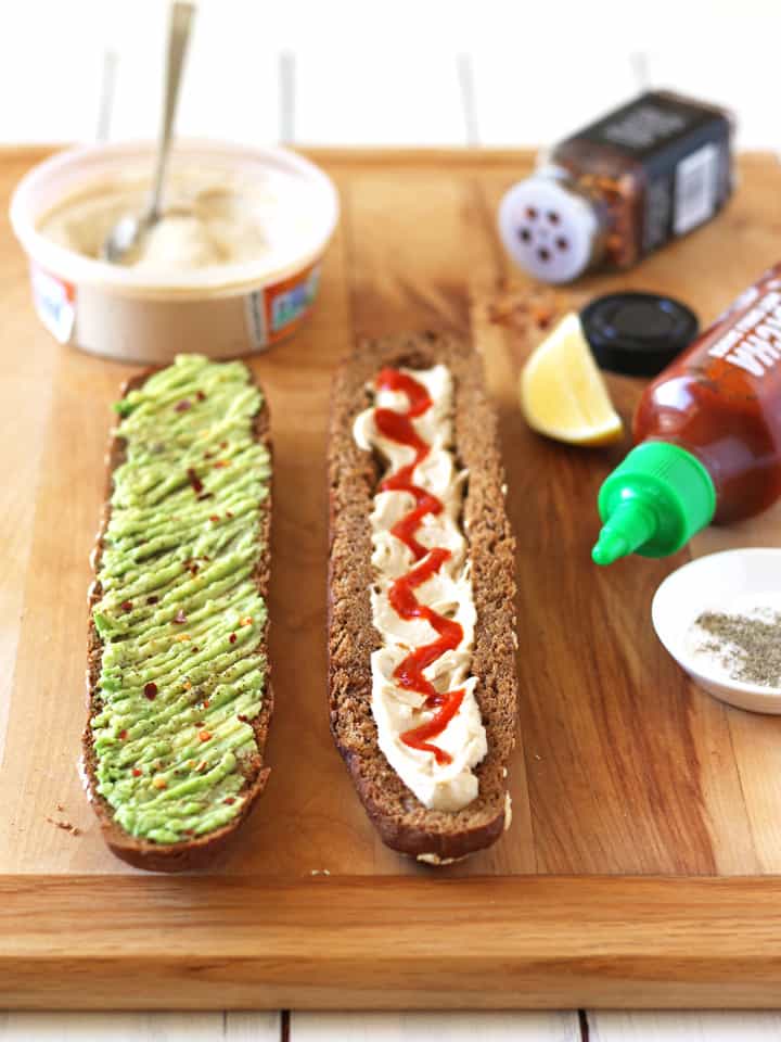 Bread halves spread with hummus and avocado.