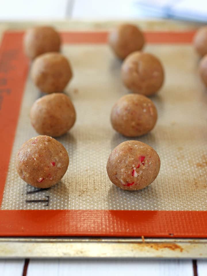 Small sheet pan with balls of raw cookie dough.