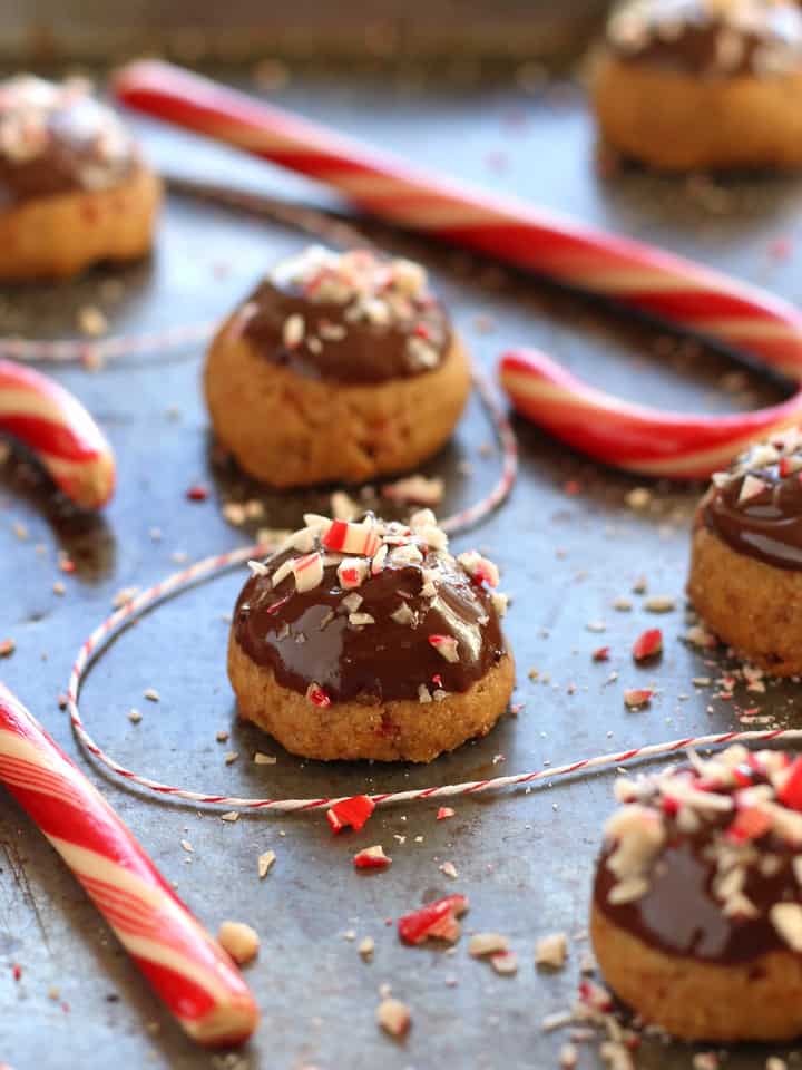 Closeup of chocolate and candy cane topped cookies.