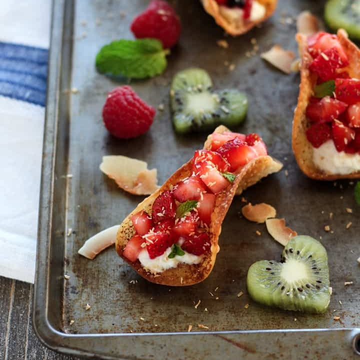 Sheet pan of fruit tacos and cut out kiwi hearts.