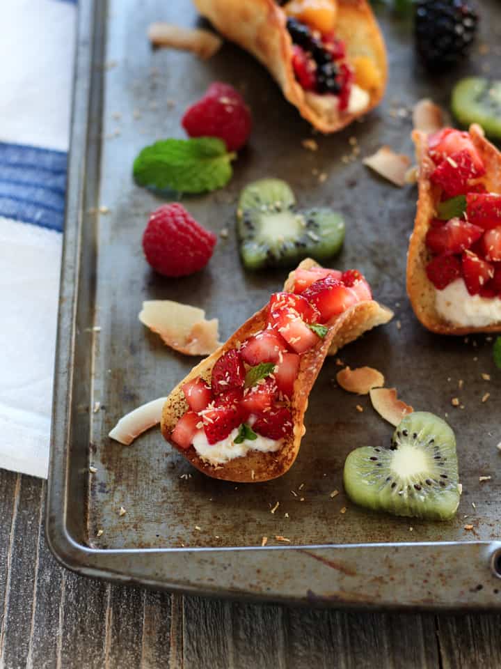 Sheet pan of fruit tacos and cut out kiwi hearts.