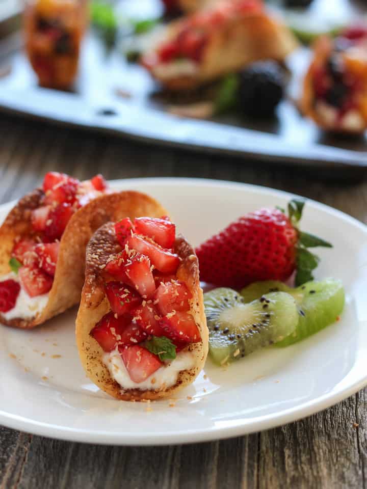 Plate of strawberry filled fruit tacos.