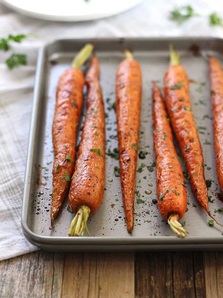 Savory roasted carrots topped with balsamic and chopped parsley.