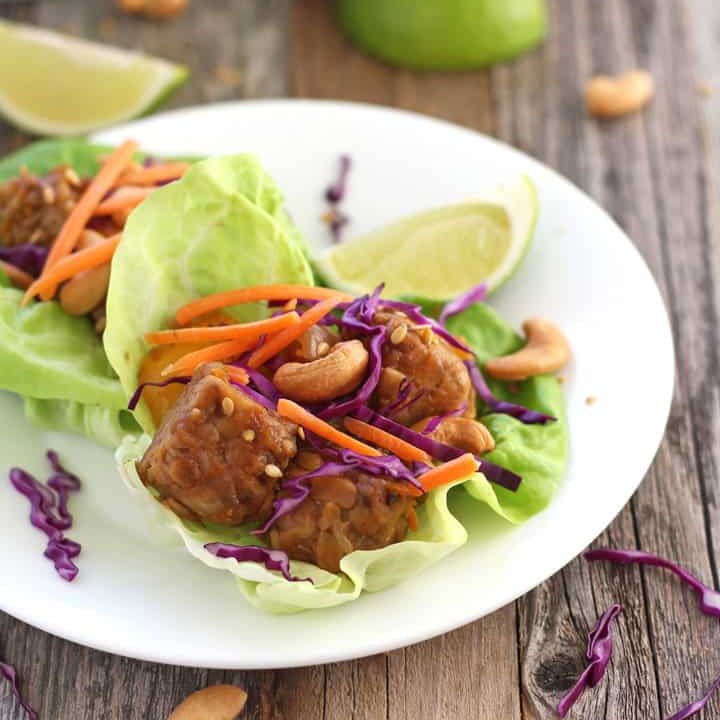 Lettuce wraps on a white plate.