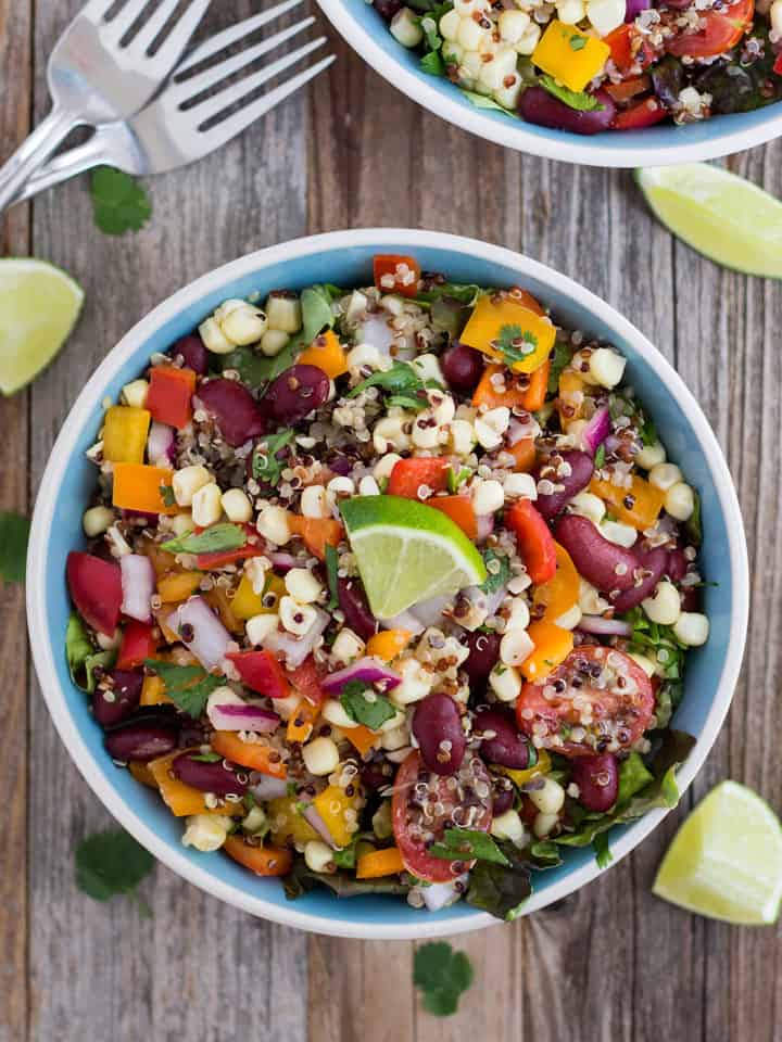 Overhead view of bowls loaded with a colorful veggie salad.