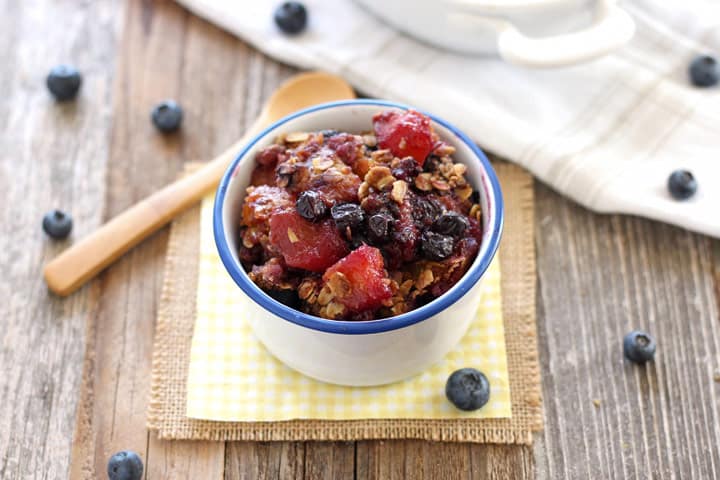 A small bowl of fruit crisp on a yellow napkin.