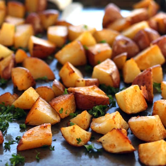 Roasted red potatoes on a baking sheet. 