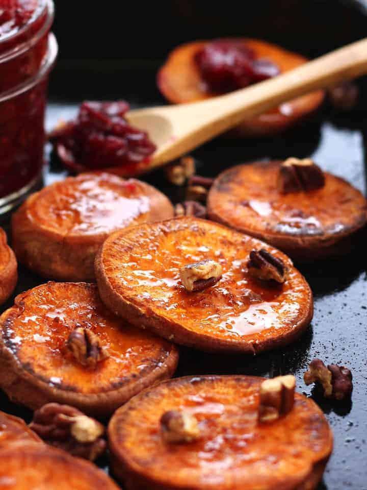 Roasted sweet potato slices on a roasting pan.