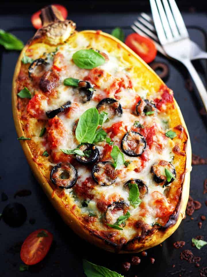 Stuffed spaghetti squash on a baking sheet.