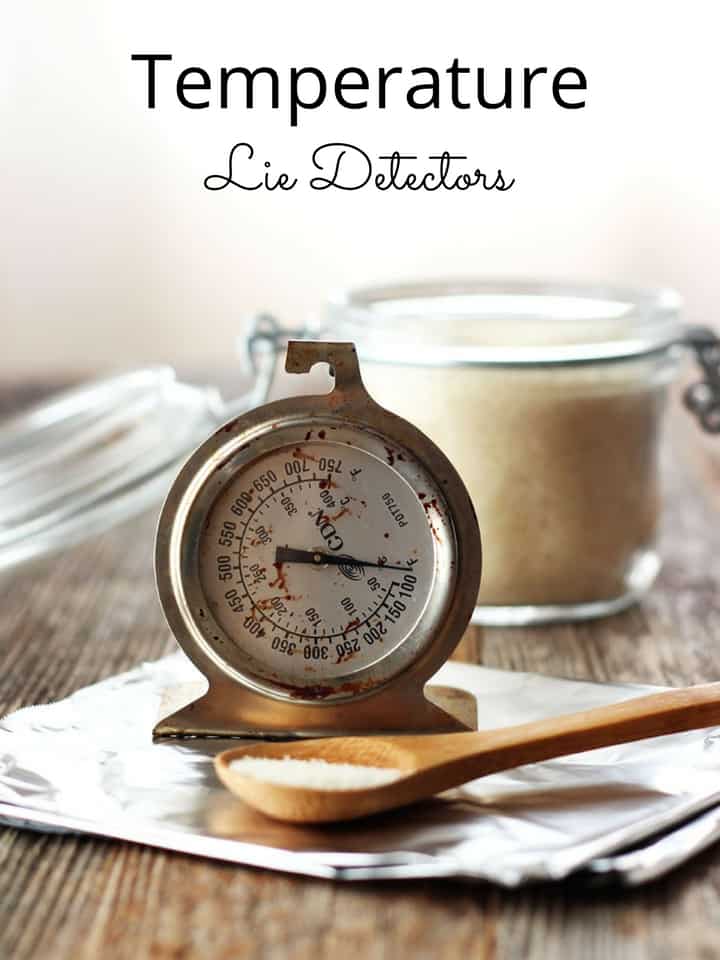 Oven thermometer and small wooden spoon of sugar on a piece of foil.