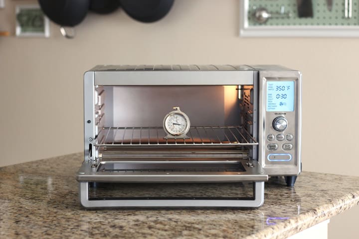 Oven thermometer inside a large toaster oven.