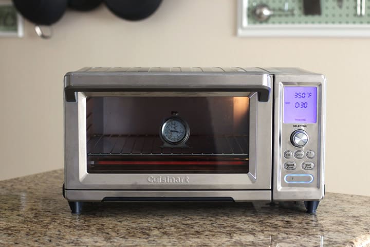 Large countertop oven with an oven thermometer inside.