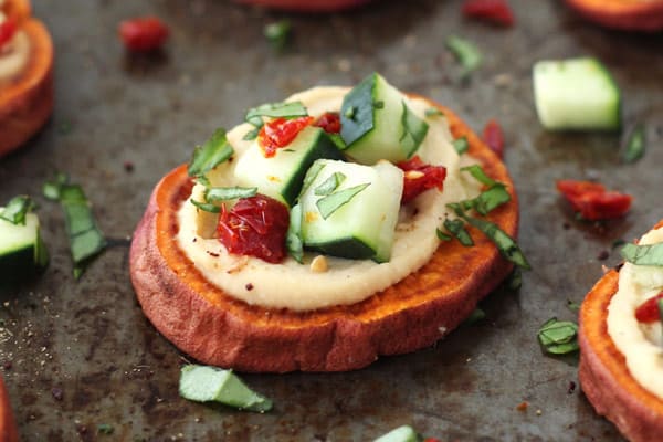 Hummus and cucumber topped sweet potato slices.