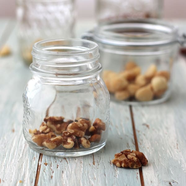 Small glass mason jars filled with nuts.