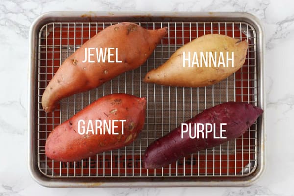 Raw Garnet, Jewel, Hannah, Purple sweet potatoes on a baking rack