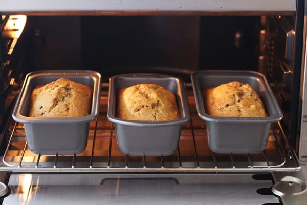 baked mini loaves side by side on a rack in a toaster oven