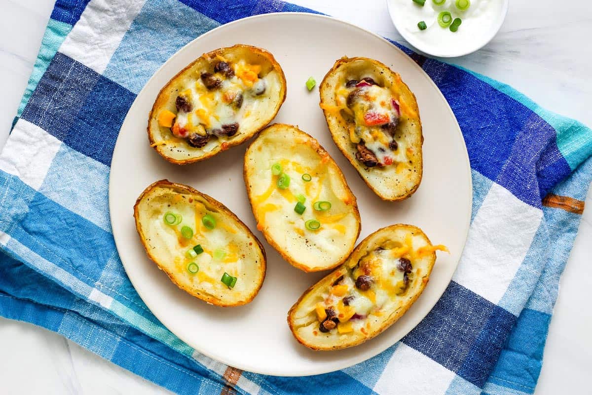 Crispy potato skins on a plate with a blue checkered napkin.