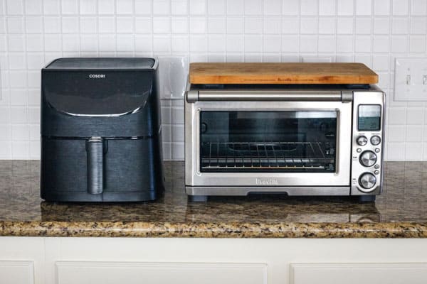 Air fryer and convection toaster oven on kitchen counter.