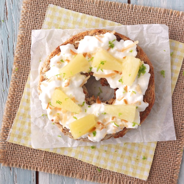 Toasted whole wheat bagel with cottage cheese, pineapple and toasted coconut.