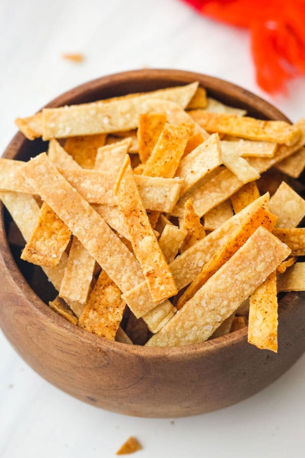 Tortilla strips in a small wooden bowl.