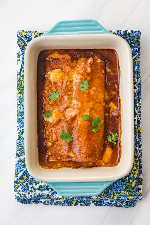 Baked frozen enchiladas in a blue 7x5 baking dish.