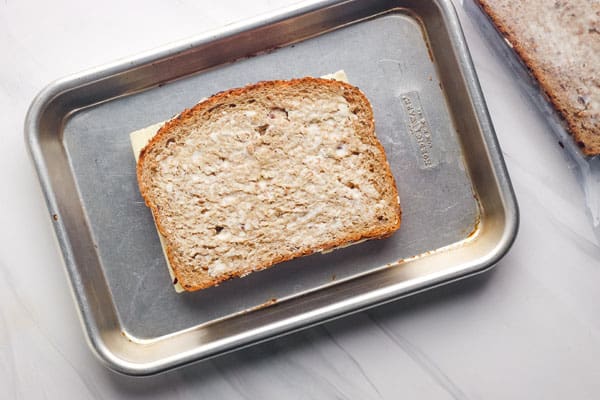 Frozen sandwich on a small baking sheet.