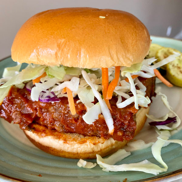 Meatloaf sandwich with slaw mix on a brioche bun. 