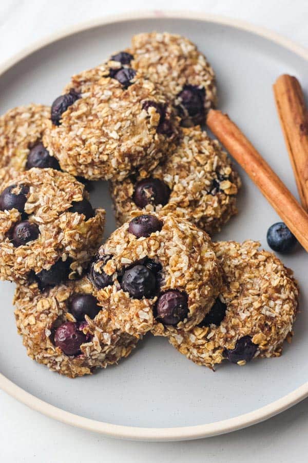 Closeup of blueberry banana oat cookies on a blue plate.