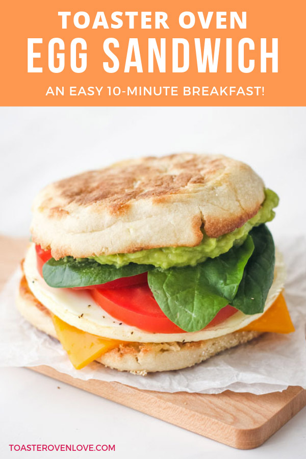 An English muffin breakfast sandwich on a small cutting board.