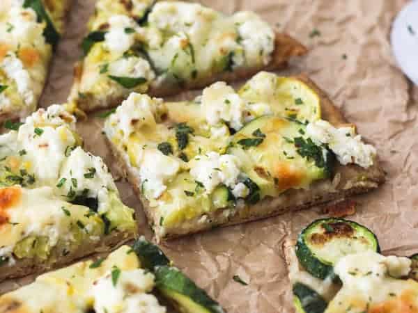 Close up of a piece of zucchini and lemon flatbread.