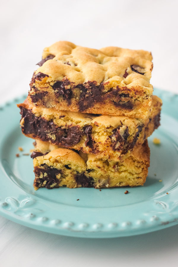 3 cookie bars stacked on a blue plate.