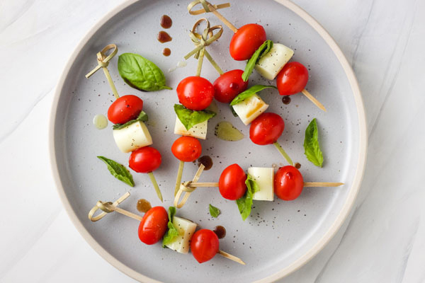 Caprese Skewers on a blue plate.