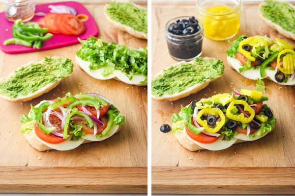 Cutting board with sandwich rolls and fresh veggies.