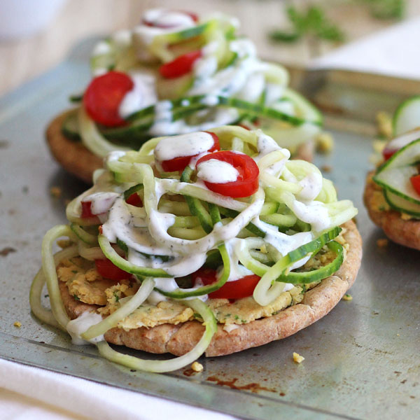 Small sheet pan with mini pita topped with spiraled cucumber.