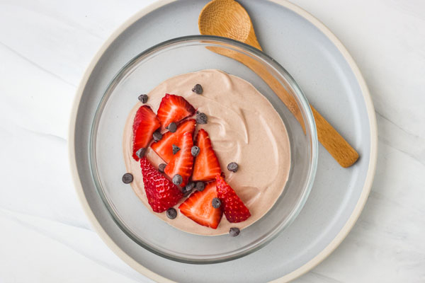 Chocolate greek yogurt in a glass bowl.