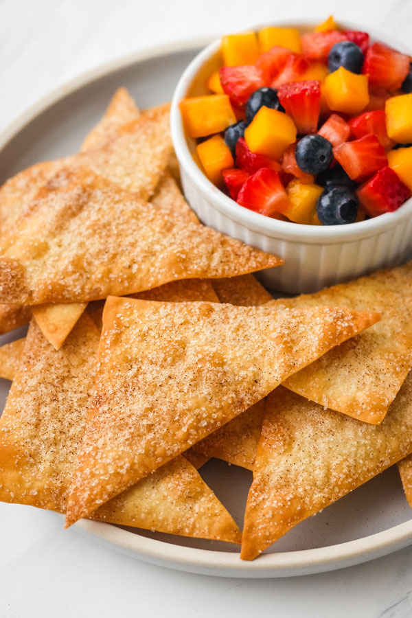 Cinnamon Baked Wonton Chips with fruit salsa on a blue plate.