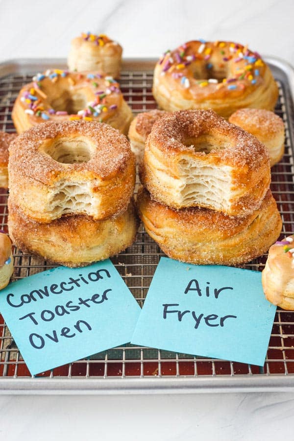 Donuts with bites taken our showing flaky layers inside.