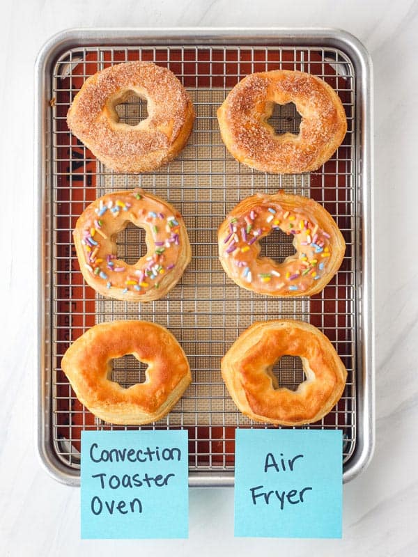 Air fried donuts on rack on sheet pan.